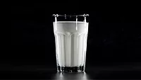 glass of milk, black background