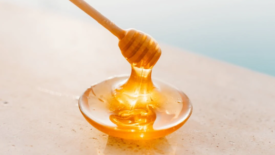 honey dripping from stick