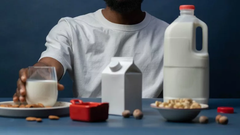 man reaching for nut milk