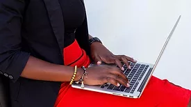 person typing on laptop