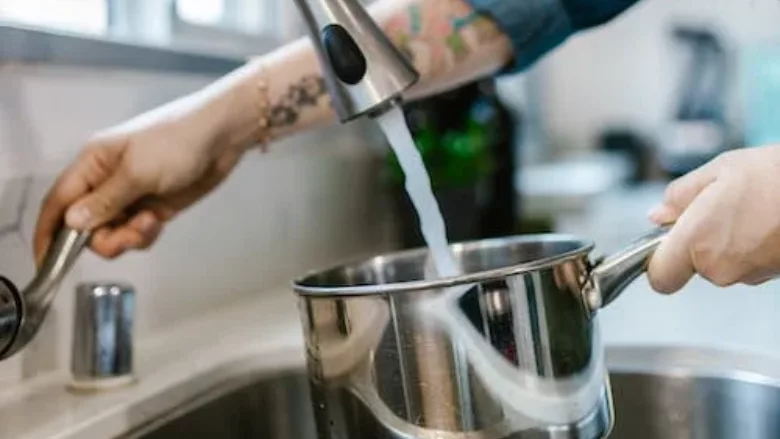 pouring tap water into pot
