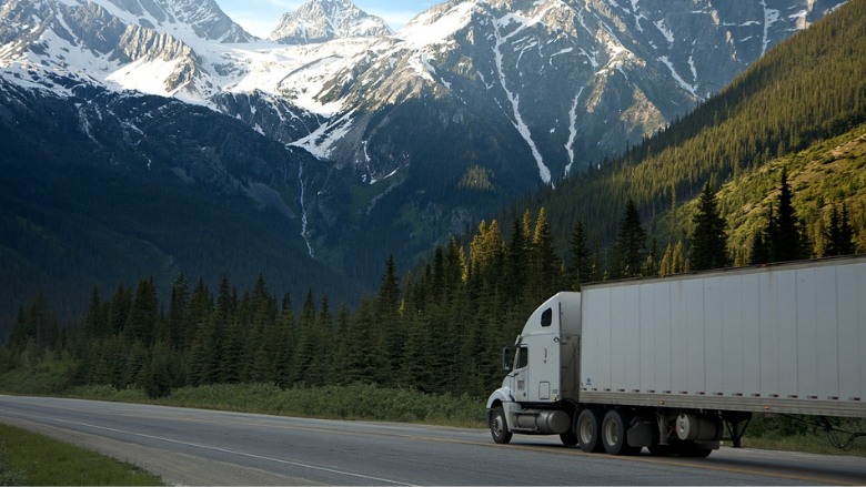 a cargo truck traveling through mountainous countryside