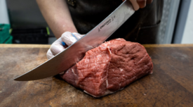 big hunk of meat being butchered