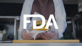 food truck worker holding burger with fda logo overlay