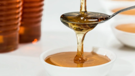 honey dripping over a spoon