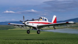 low flying plane spraying crops