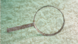 magnifying glass and white powder