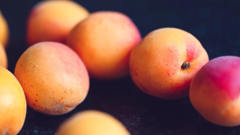 peaches against a black background