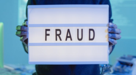 person holding a sign that says fraud