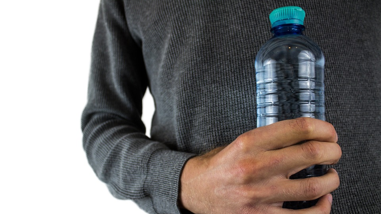 person holding water bottle