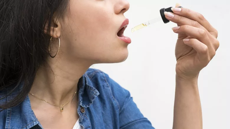 person ingesting cbd oil