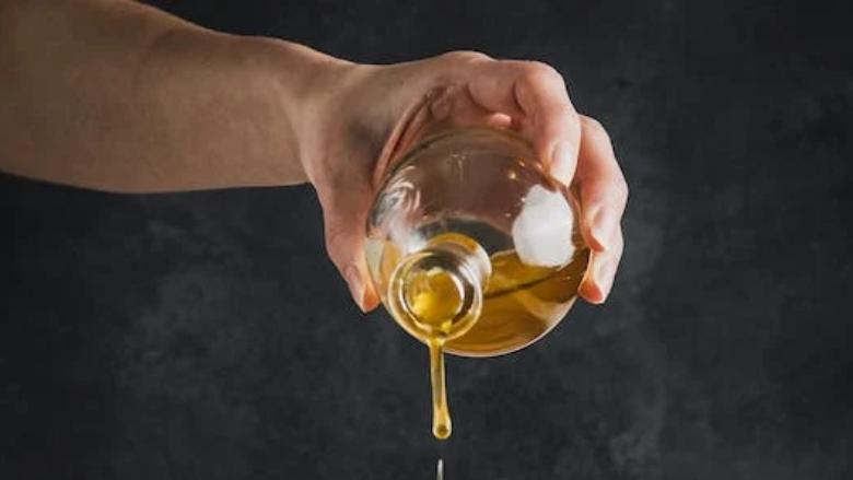 person pouring oil