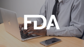 person using laptop with fda logo overlay