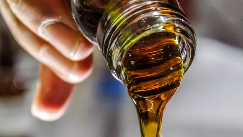 pouring oil out of jar