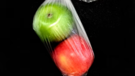 red and green apples in a plastic bag
