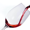 red wine being poured against white background