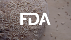 Sesame seeds on a roll with FDA logo overlay