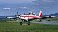 small low-flying plane spraying chemicals on crops