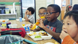 students eating lunch in a school cafeteria