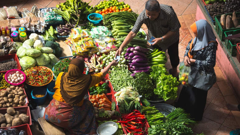 people trading produce at a traditional market