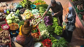 people trading produce at a traditional market