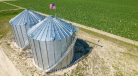 aerial view of grain silos and crop field 