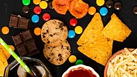 assortment of processed food- chips candy cookies soda fries ketchup assortment of processed food- chips candy cookies soda fries ketchup