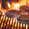 burger patties on grill flame