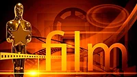 gold award next to text that says film against orange background with reels and reel tape gold award next to text that says film against orange background with reels and reel tape