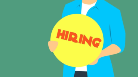 graphic of a person holding a round yellow sign that says hiring