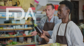 grocery store workers looking at an eggplant with fda logo overlay