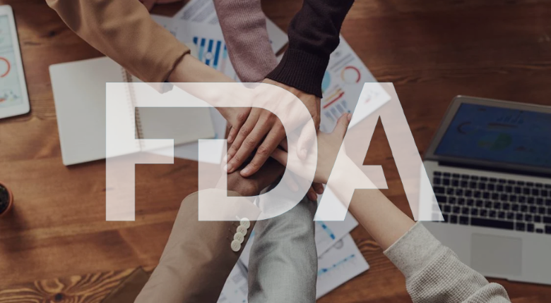 group of hands doing a hands-in over work table in corporate clothes with FDA logo overlay
