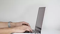 hands using laptop