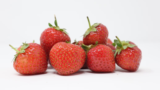 small pile of strawberries white background