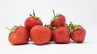small pile of strawberries white background