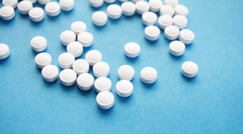 white round pills on blue background