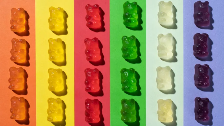 colorful gummy bears on multicolored background