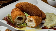 cooked chicken kiev plated with mashed potatoes