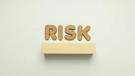 corkboard letters spelling risk