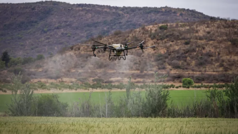 drone spraying pesticides on crops