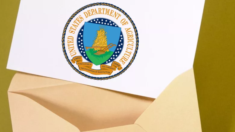 envelope open with piece of paper coming out with USDA seal on it