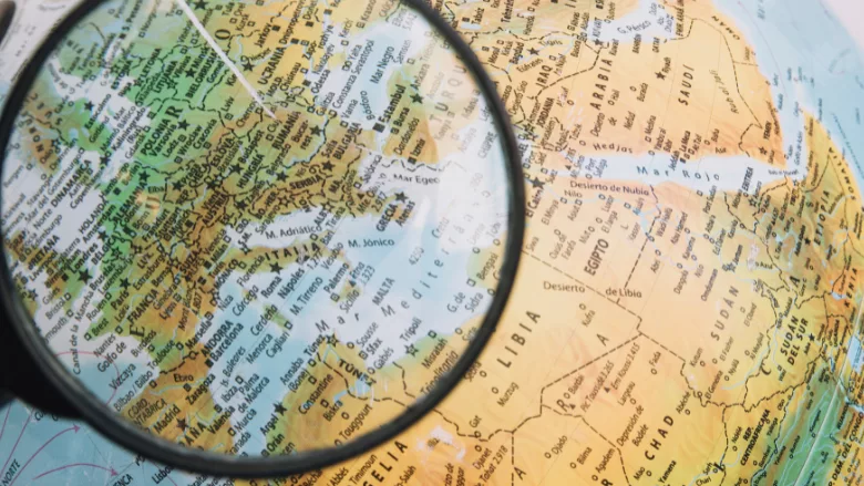 magnifying glass hovering over europe on globe