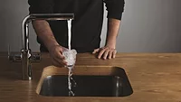 man filling glass with tap water.png tap water
