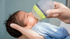 newborn earing from bottle