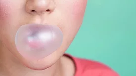 person blowing bubble of gum