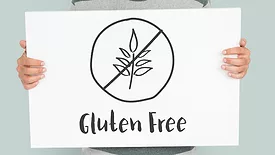 person holding sign that says gluten-free