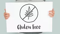 person holding sign that says gluten-free person holding sign that says gluten-free