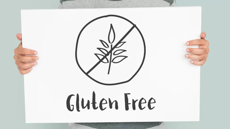 person holding sign that says gluten-free