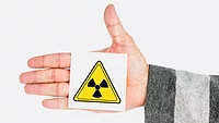 radioactivity symbol on person's hand radioactivity symbol on person's hand