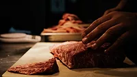 raw meat being cut dark lighting raw meat being cut dark lighting